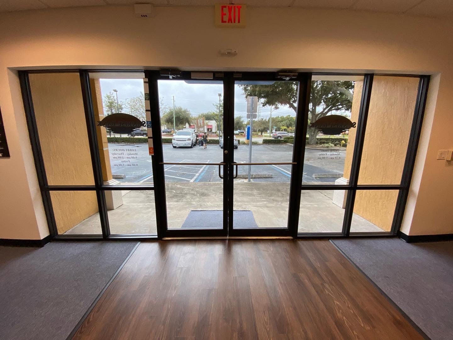 Inside view looking out through the same Sunrise Bank glass doors — clear visibility